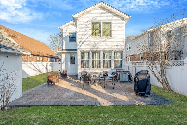 back of house with a yard, a patio area, and a fenced backyard