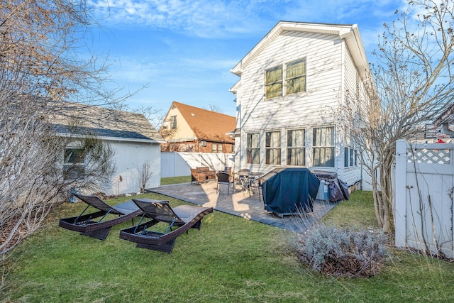 rear view of property with a patio, a yard, and a fenced backyard