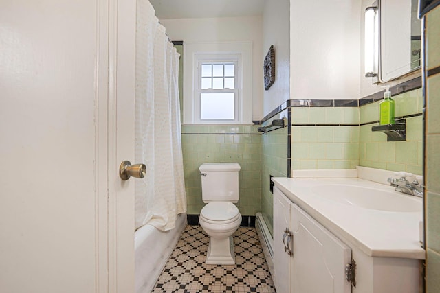 full bath with toilet, a wainscoted wall, vanity, tile walls, and baseboard heating