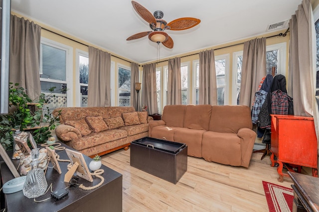 living room featuring ceiling fan, visible vents, and wood finished floors