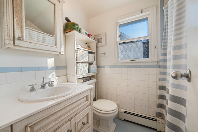 full bath with wainscoting, toilet, baseboard heating, vanity, and tile walls