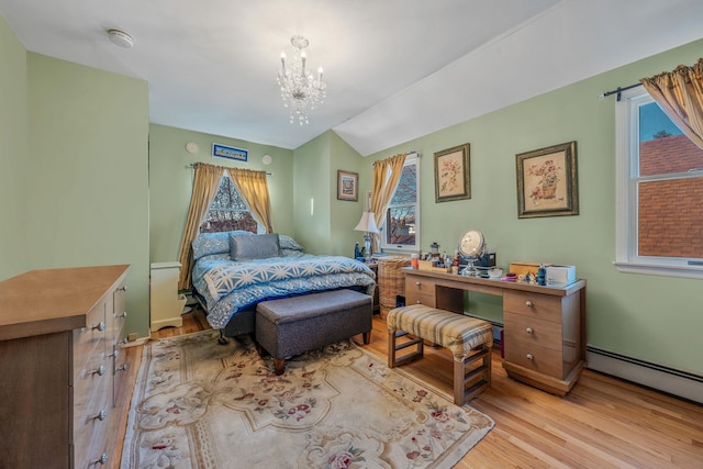 bedroom featuring a chandelier, a baseboard radiator, wood finished floors, and lofted ceiling