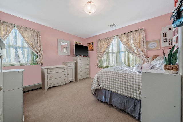 bedroom with visible vents, light carpet, and baseboard heating