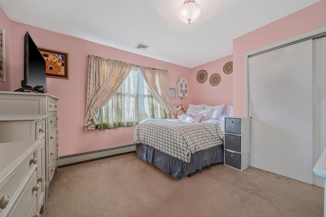 bedroom featuring a closet, visible vents, light carpet, and baseboard heating