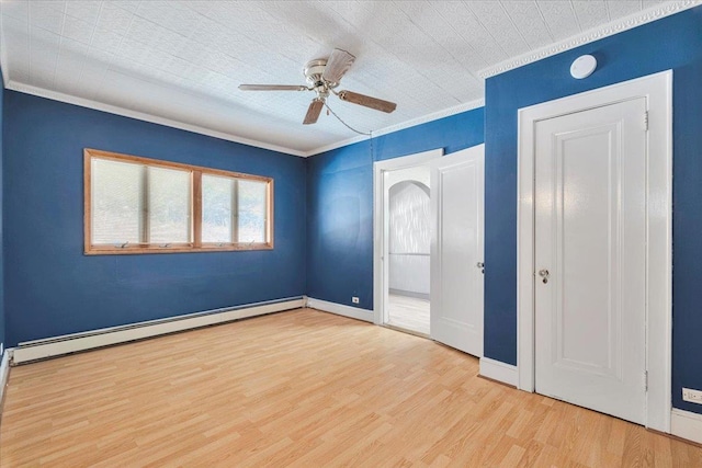 unfurnished bedroom with light wood finished floors, ornamental molding, a baseboard radiator, and baseboards