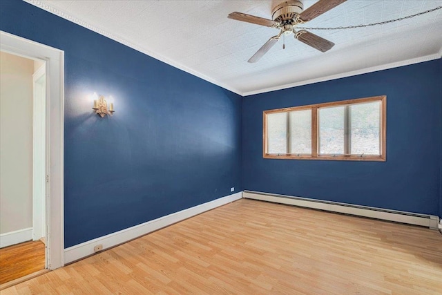 empty room with wood finished floors, a ceiling fan, baseboards, baseboard heating, and crown molding