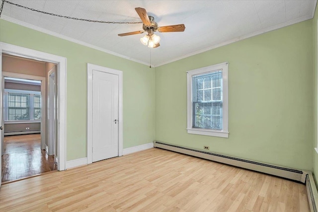 unfurnished bedroom with ornamental molding, light wood finished floors, a baseboard radiator, and baseboards