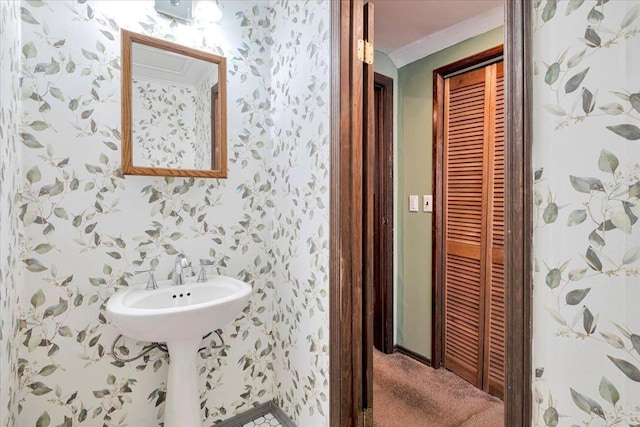 bathroom featuring a closet and wallpapered walls