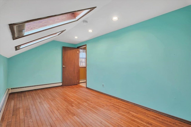 bonus room with light wood-style floors, recessed lighting, lofted ceiling with skylight, and baseboard heating