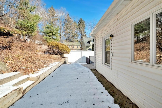 view of side of home featuring fence