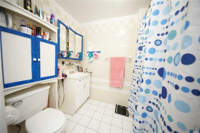 bathroom with vanity, tile patterned flooring, a shower with shower curtain, and toilet