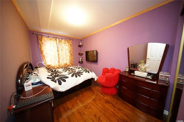 bedroom with hardwood / wood-style flooring and ornamental molding