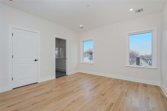 spare room with light hardwood / wood-style flooring