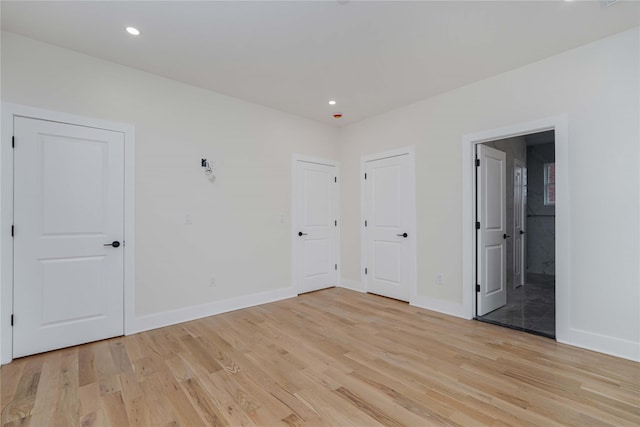 unfurnished room with light hardwood / wood-style flooring