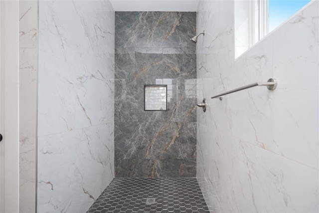 bathroom with tiled shower