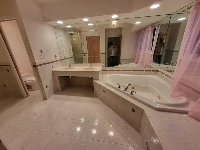 full bathroom with tile patterned flooring, toilet, tile walls, shower with separate bathtub, and vanity