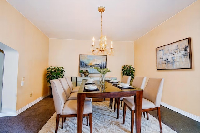 dining area featuring carpet floors and a notable chandelier