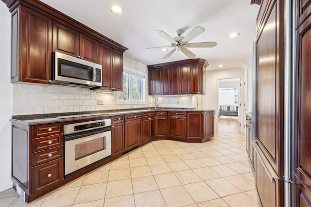 kitchen with light tile patterned floors, ceiling fan, recessed lighting, stainless steel appliances, and tasteful backsplash