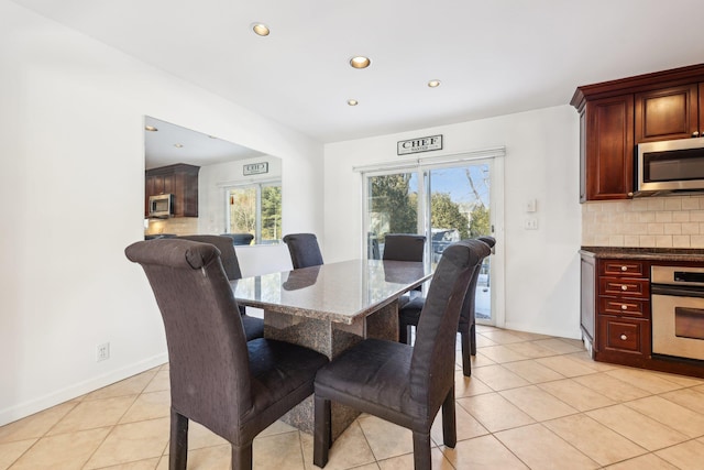 dining room with light tile patterned floors, baseboards, and recessed lighting