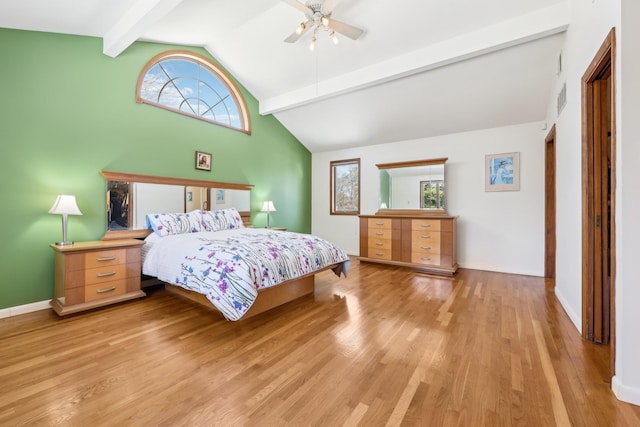 bedroom with a ceiling fan, visible vents, vaulted ceiling with beams, and light wood finished floors