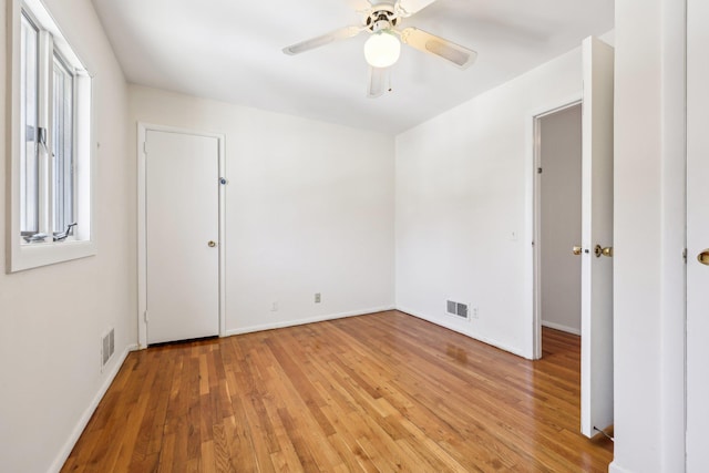 unfurnished bedroom with baseboards, ceiling fan, visible vents, and light wood-style floors