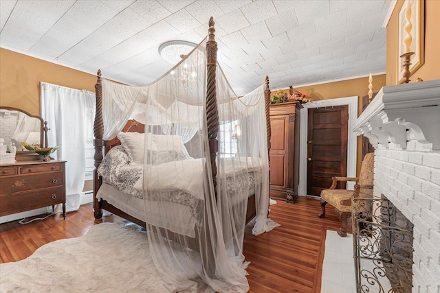 bedroom featuring ornamental molding and hardwood / wood-style floors