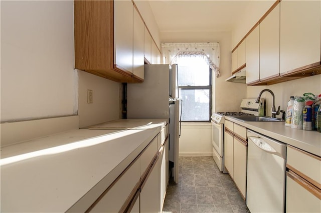 kitchen with sink, white appliances, and white cabinetry