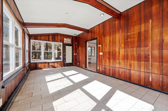 unfurnished sunroom with vaulted ceiling with beams and radiator heating unit