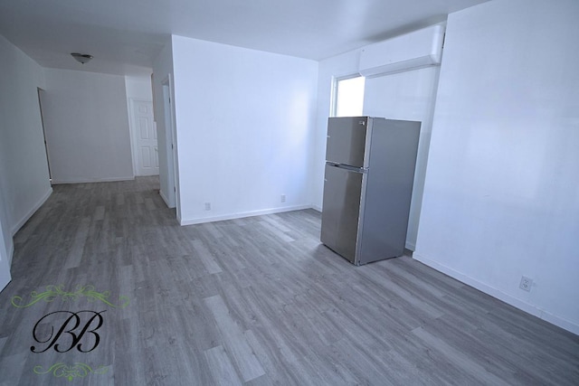 empty room with dark wood-type flooring and a wall mounted AC