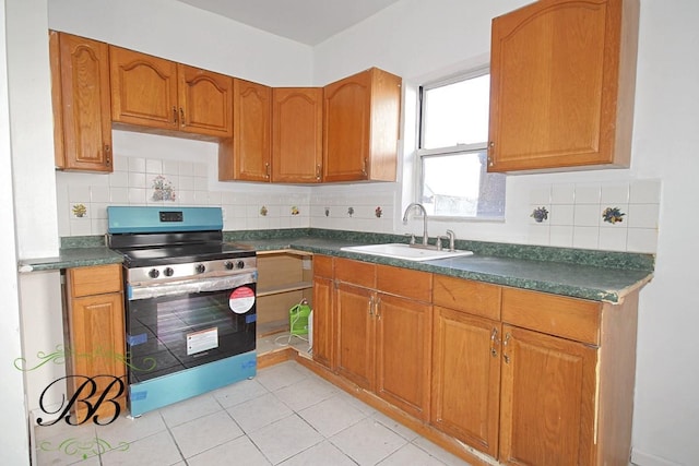 kitchen with sink, tasteful backsplash, stainless steel electric stove, and light tile patterned flooring