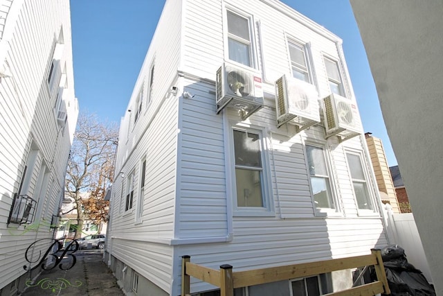 view of side of home with ac unit