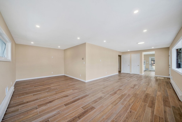 unfurnished living room featuring light wood-style floors, baseboards, and recessed lighting