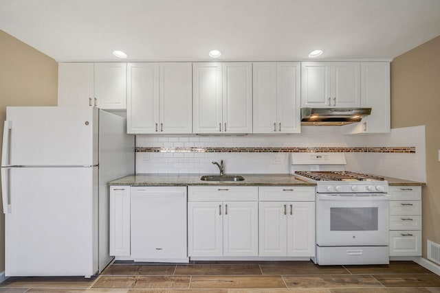 kitchen featuring under cabinet range hood, white appliances, a sink, white cabinetry, and wood tiled floor