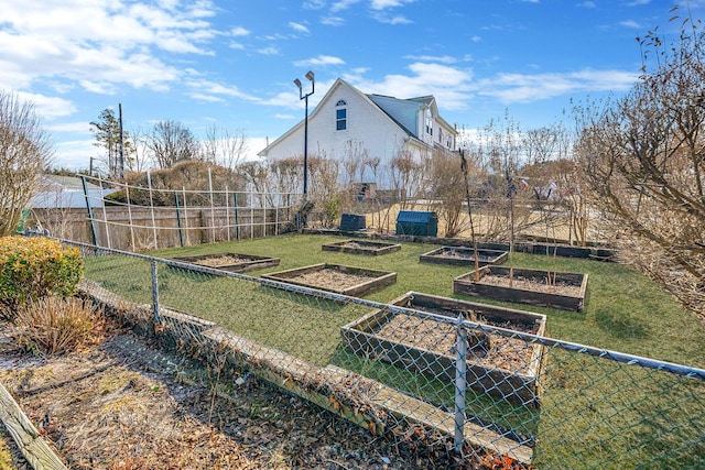 view of yard with fence and a vegetable garden