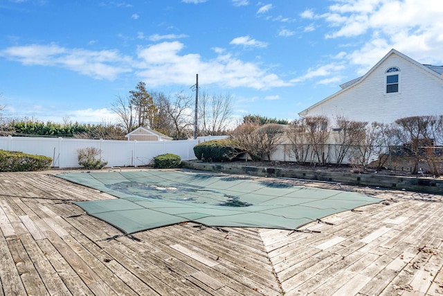 view of swimming pool with a deck, a fenced backyard, and a fenced in pool