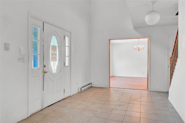 entrance foyer with baseboard heating and a notable chandelier