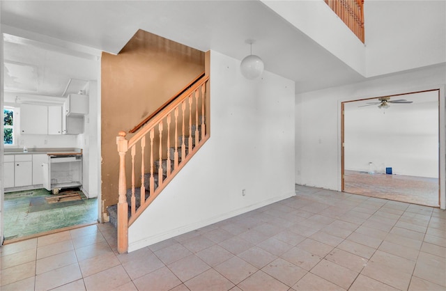 interior space with ceiling fan and tile patterned flooring