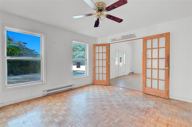 spare room with plenty of natural light, ceiling fan, light parquet floors, and a baseboard radiator