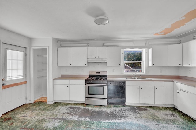 kitchen with stainless steel range with gas stovetop, white cabinetry, sink, and black dishwasher