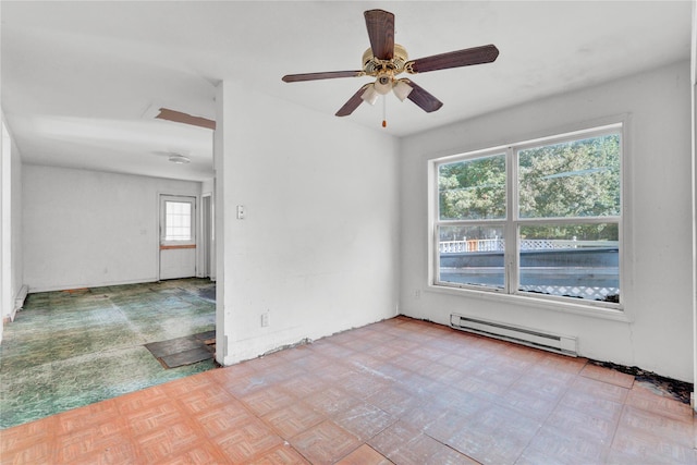 spare room with ceiling fan, light parquet floors, and baseboard heating