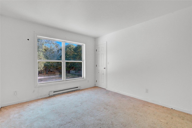 carpeted spare room with baseboard heating