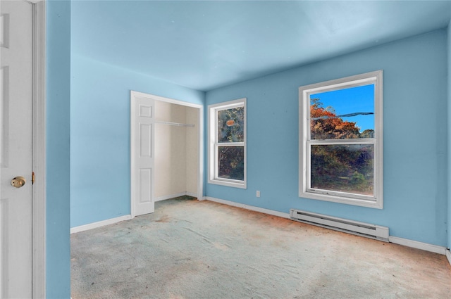 unfurnished bedroom with light carpet, a baseboard radiator, and a closet