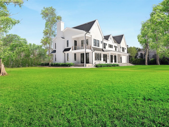 rear view of house with a yard