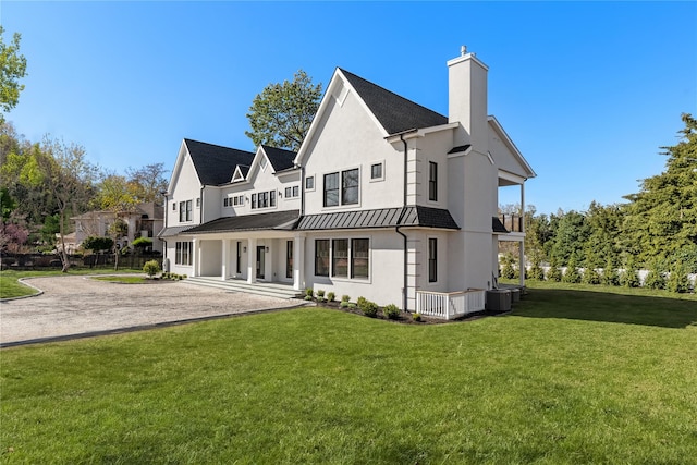 110 Crescent Ct, Wading River, NY 11792 - rear view of property featuring a chimney, a yard, central AC unit, and stucco siding