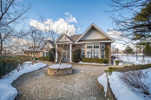 view of home's community featuring an outdoor fire pit