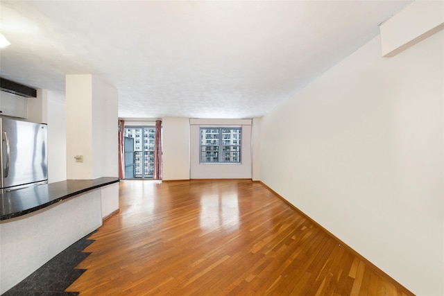 unfurnished living room featuring hardwood / wood-style floors