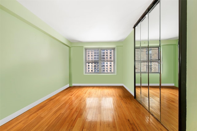 unfurnished room with light hardwood / wood-style floors