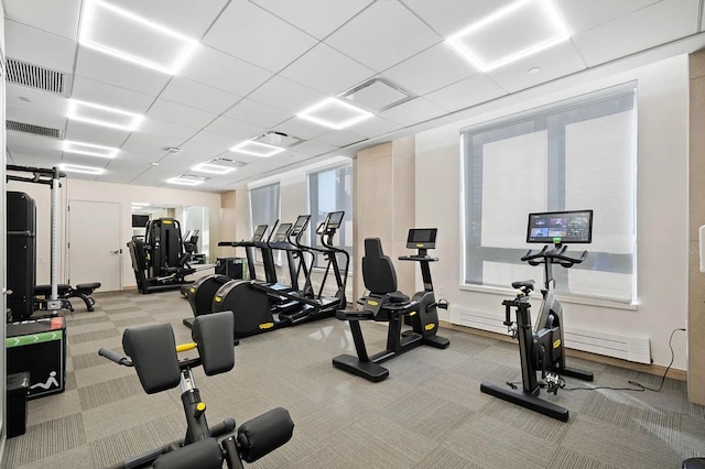 gym featuring a drop ceiling and light colored carpet