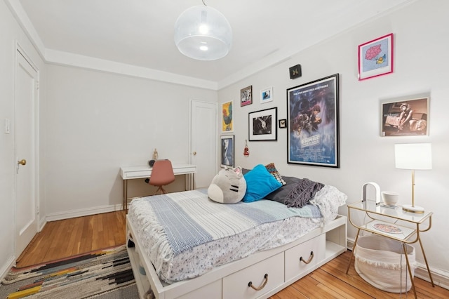 bedroom featuring baseboards and wood finished floors