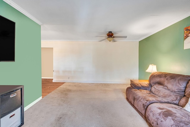 living room featuring ceiling fan, crown molding, and carpet flooring